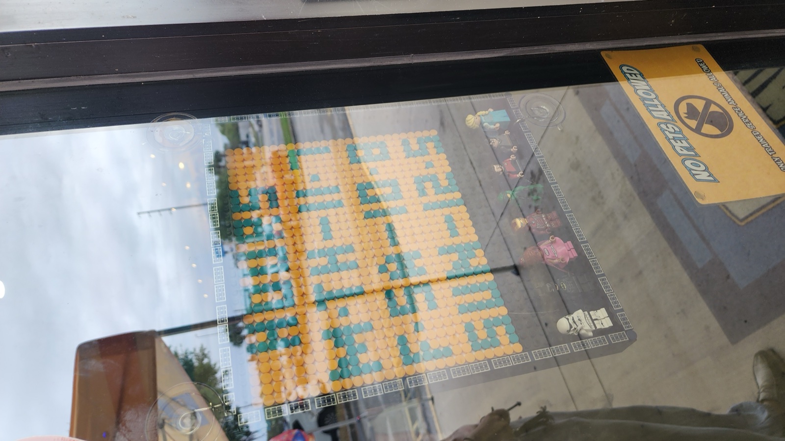 Brick mosaic artwork in the storefront window