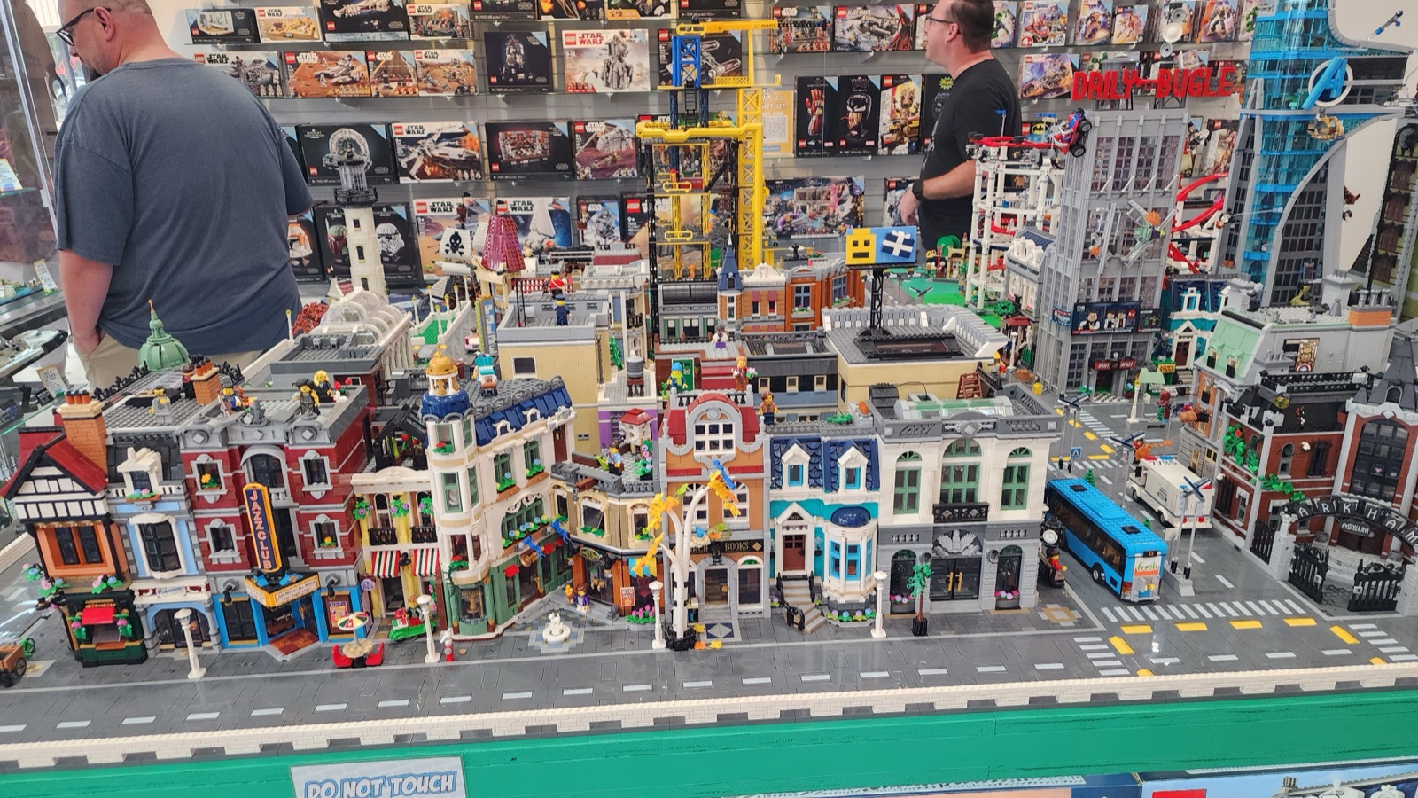 The full LEGO city display at Bricks and Minifigs Leesburg  -  modular buildings, retired sets on the wall behind