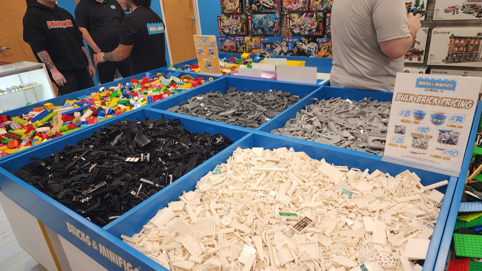 The bulk brick tables at Bricks and Minifigs  -  sorted by color with bulk pricing sign