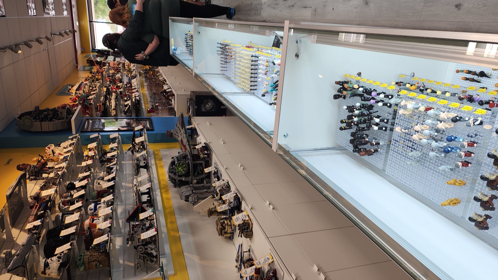 Display cases full of minifigures, vehicles, and accessories