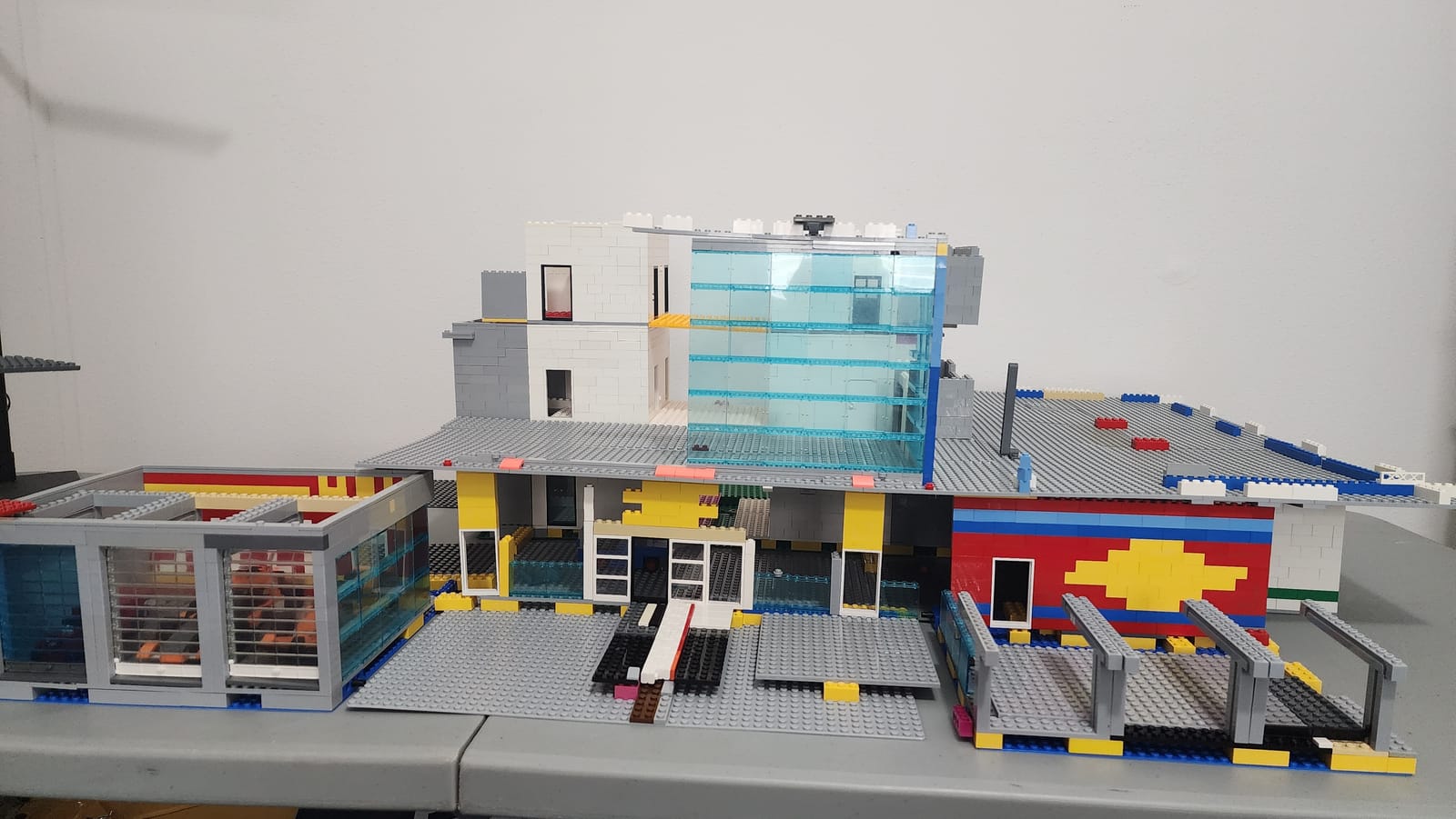 Front facade of the IMS Pagoda LEGO build showing the Chevrolet and Shell logo walls visible through the garage bays